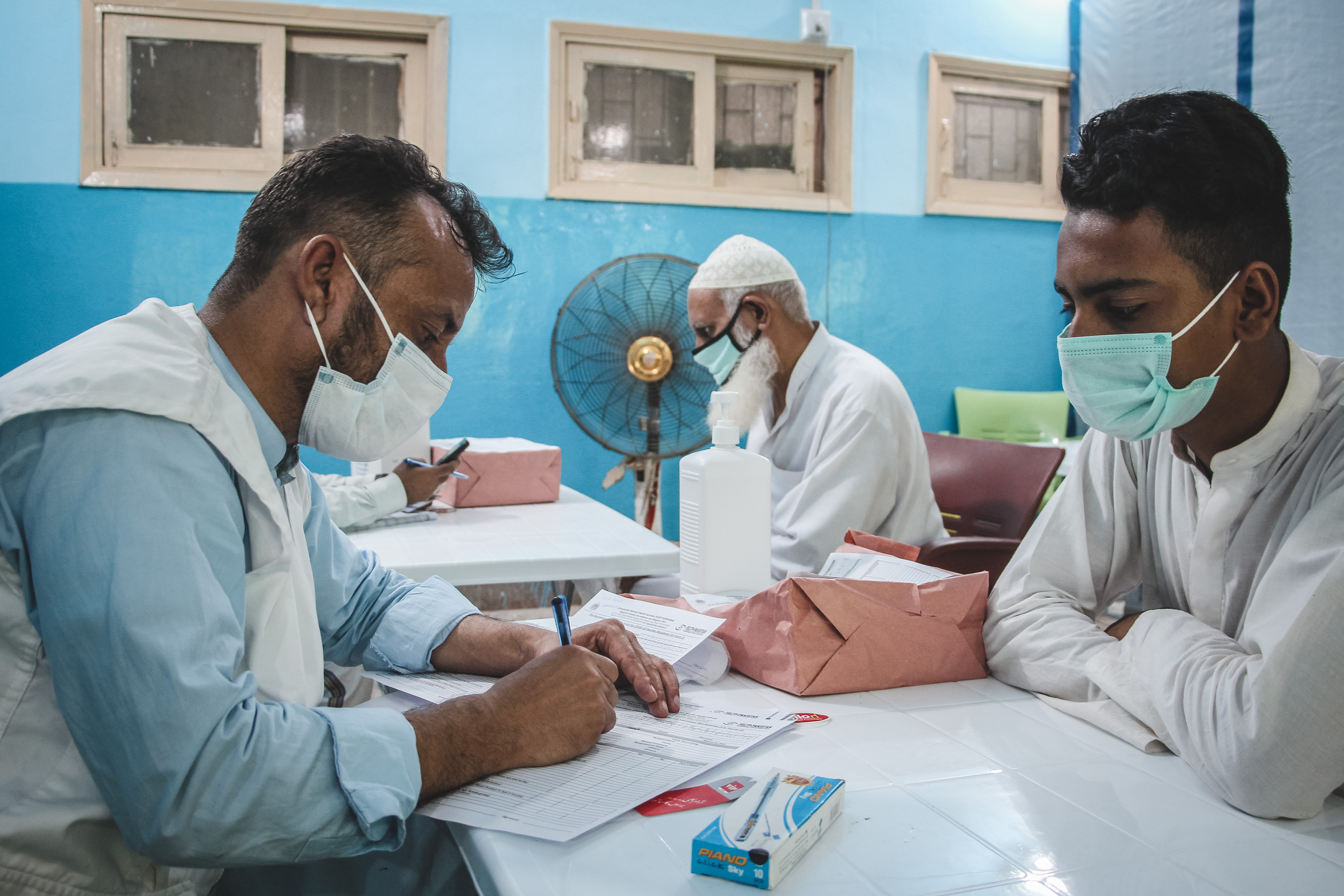  PAKISTAN - Karachi C19 Vaccination 09 An MSF doctor taking the medical history of someone coming for their COVID-19 vaccination. They check if he has any symptoms of COVID, or is currently taking any medication.